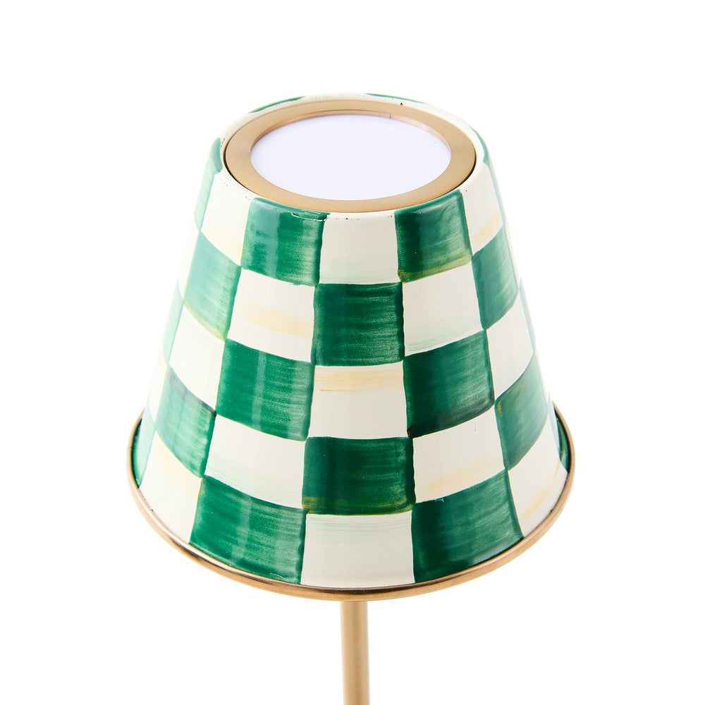 Close-up of an emerald green and white hand-painted checkered lampshade with a gold rim.