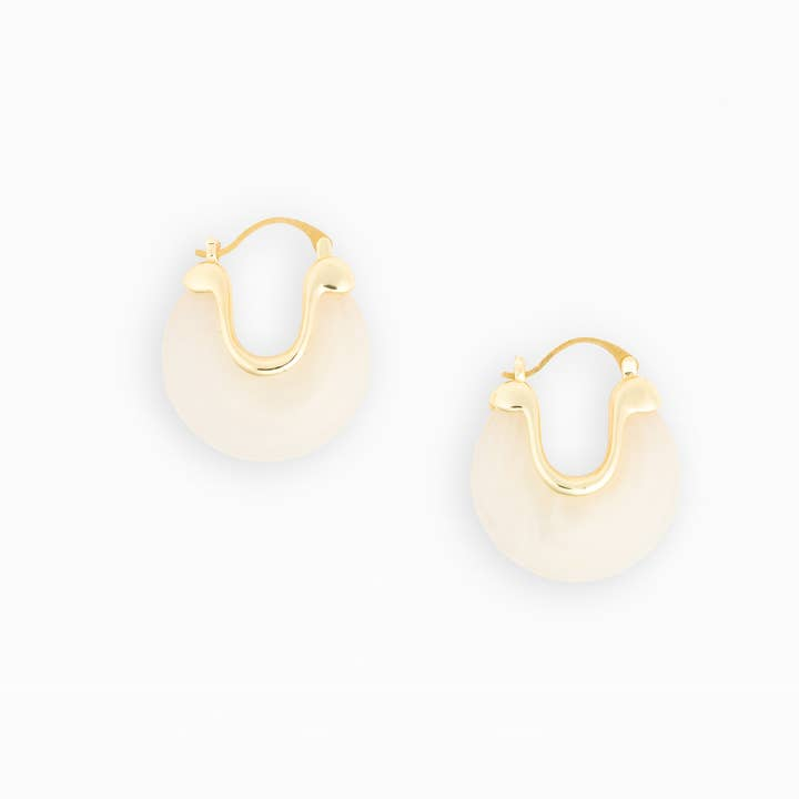 Mabel Earrings featuring a gold-plated brass frame with a white resin hoop design.