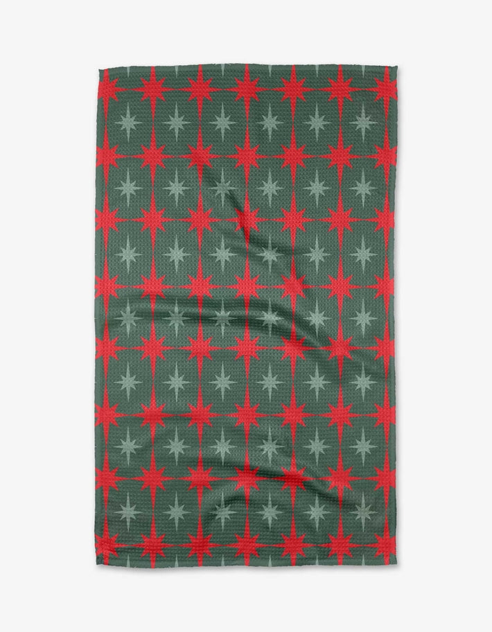 Holiday tea towel with waffle weave construction in red featuring a festive holiday pattern.