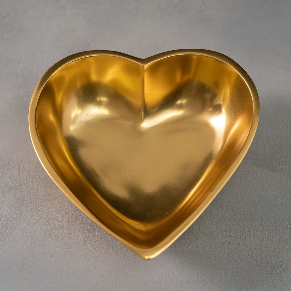 Large polished gold aluminum heart-shaped serving bowl with smooth rim.