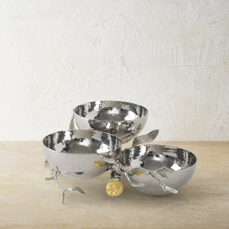 Triple stainless steel bowl set with silver finish, gold accents, and pomegranate silhouette design.
