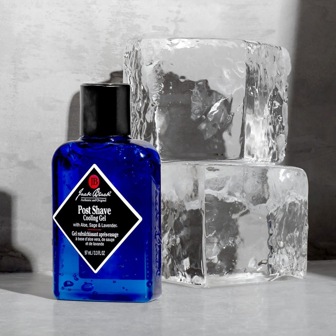 Jack Black Post Shave Cooling Gel in a blue bottle next to two ice cubes.