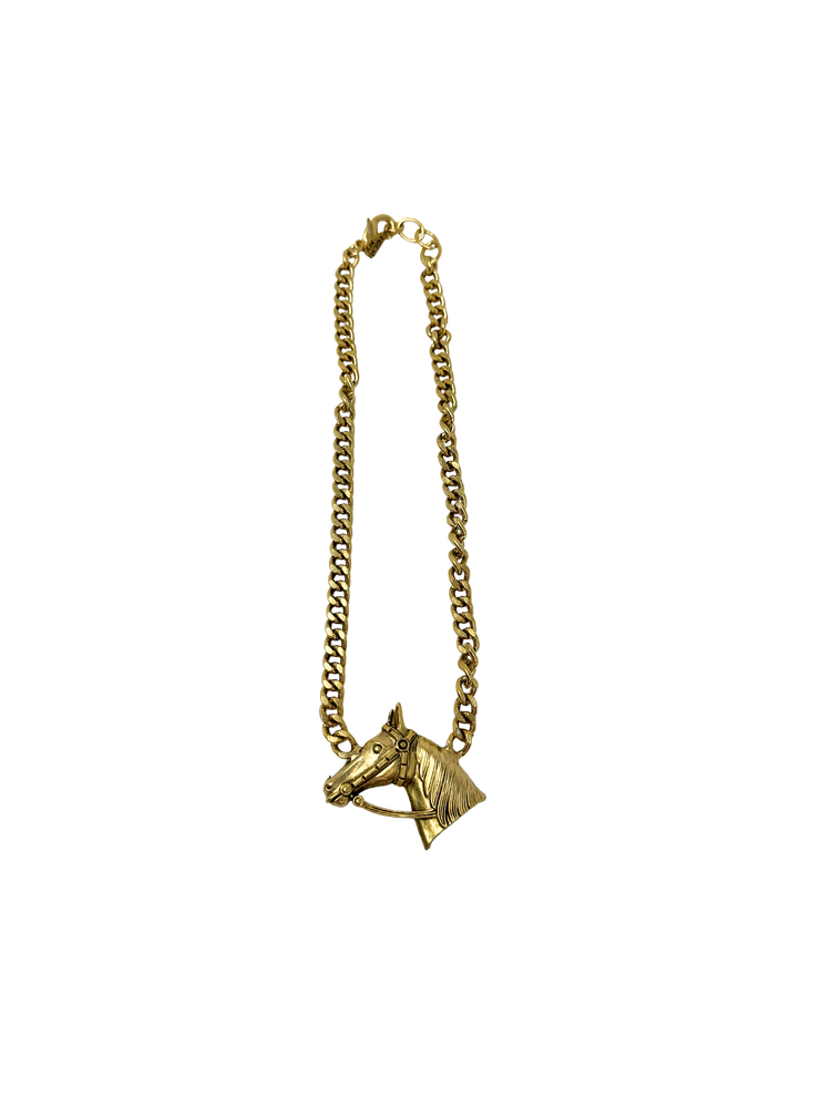 Gold chain necklace featuring a detailed horse head pendant with a bridle.
