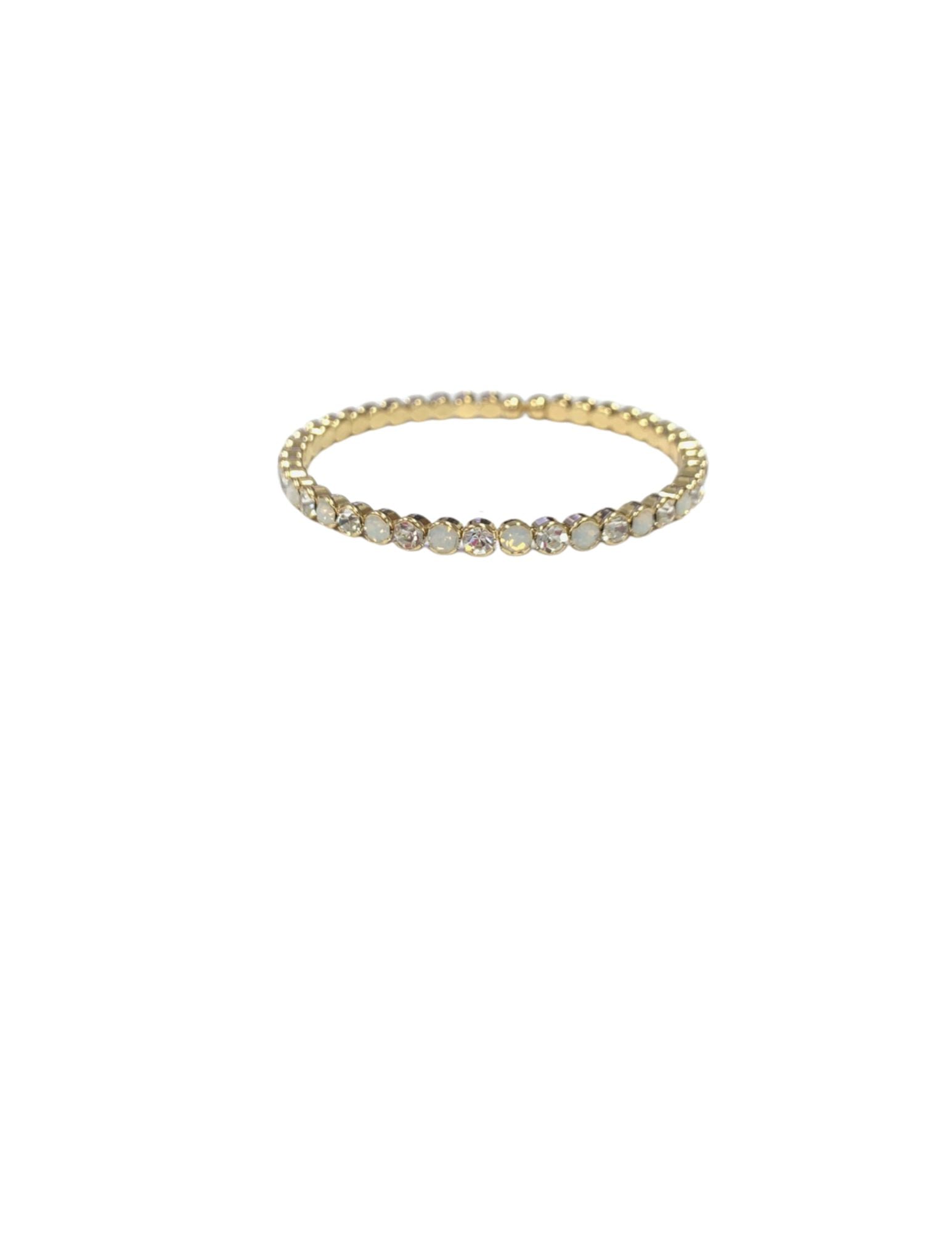 Multi stone gold stretch cuff bracelet featuring alternating clear and opal-like round crystals.