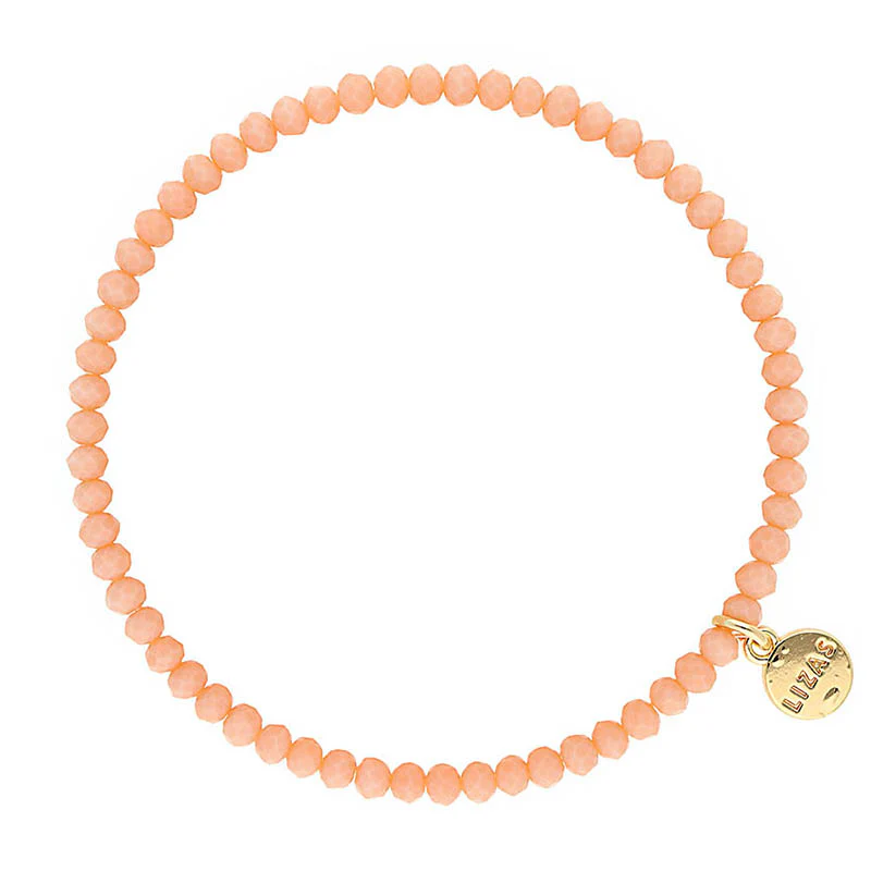 Lizas Quadro Big Bright Colours peach crystal bead stretch bracelet with a gold logo charm.