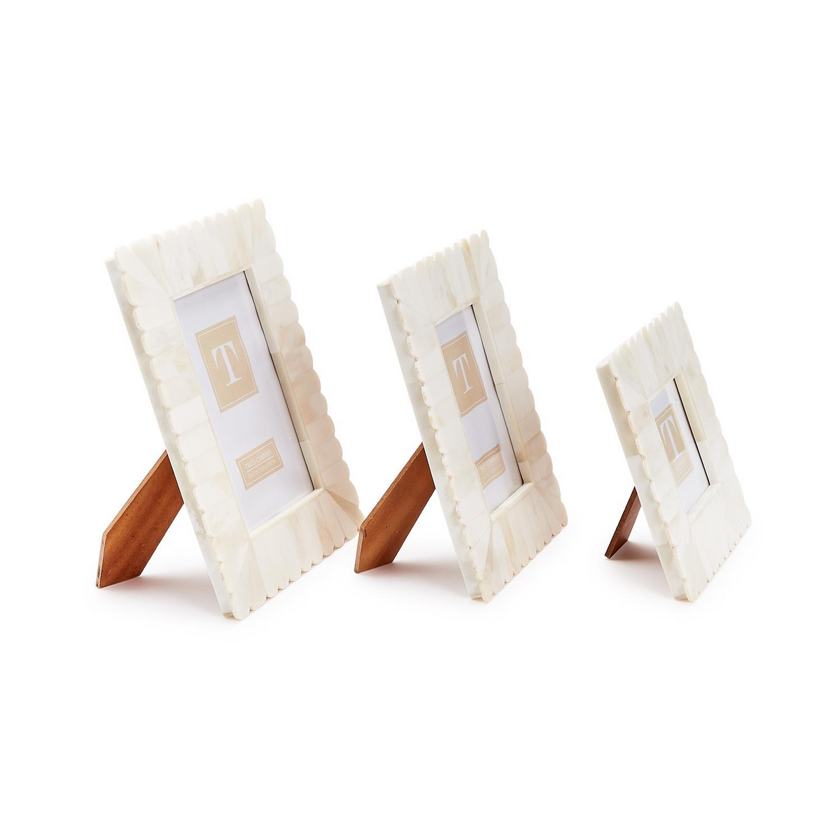 Three white bone scalloped photo frames in varying sizes with wooden easel stands.