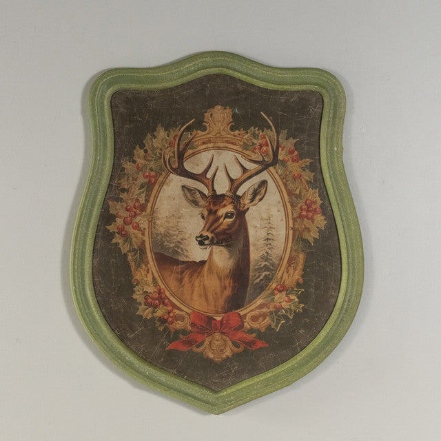 Framed holiday stag print on glass with wood frame showing a brown deer silhouette against a festive background.