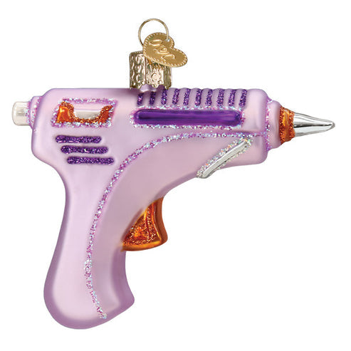 Pink glittery glass hot glue gun Christmas ornament with a gold heart charm.
