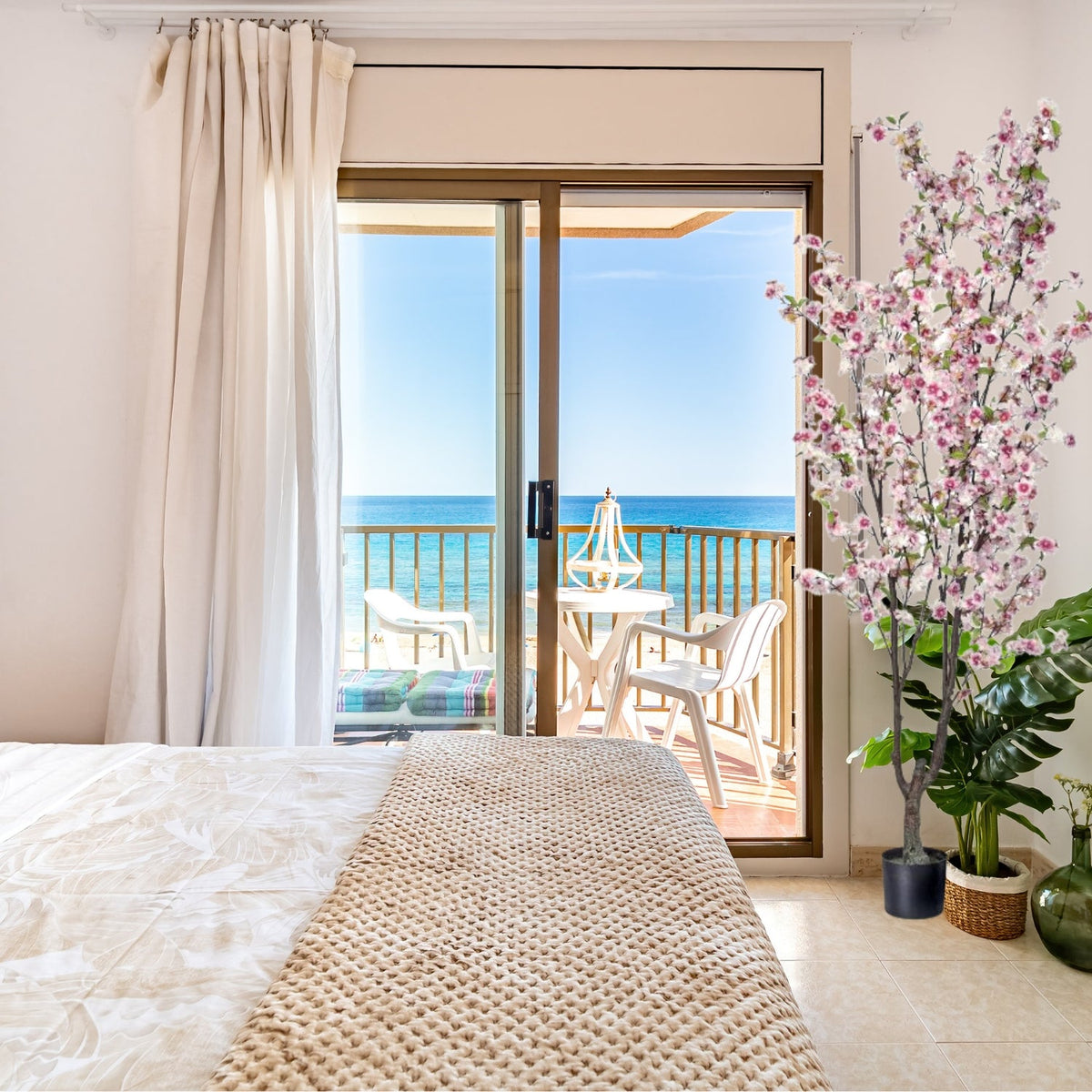 Silk cherry blossom tree in a black resin planter pot.