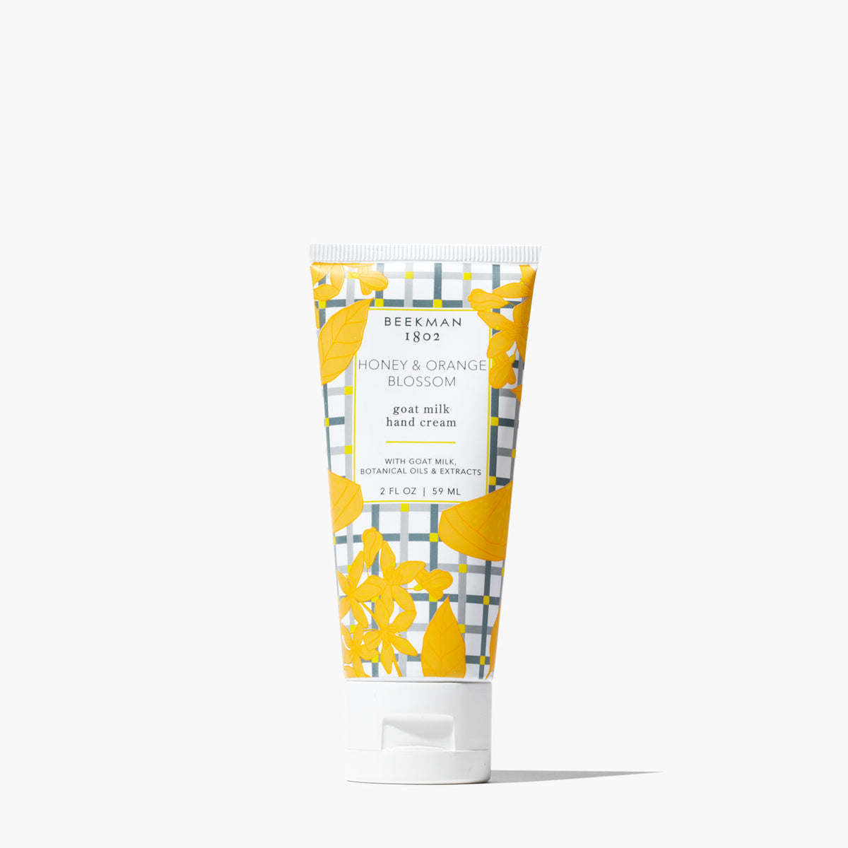 Beekman 1802 Honey & Orange Blossom goat milk hand cream in a 2 oz squeeze tube with plaid pattern.
