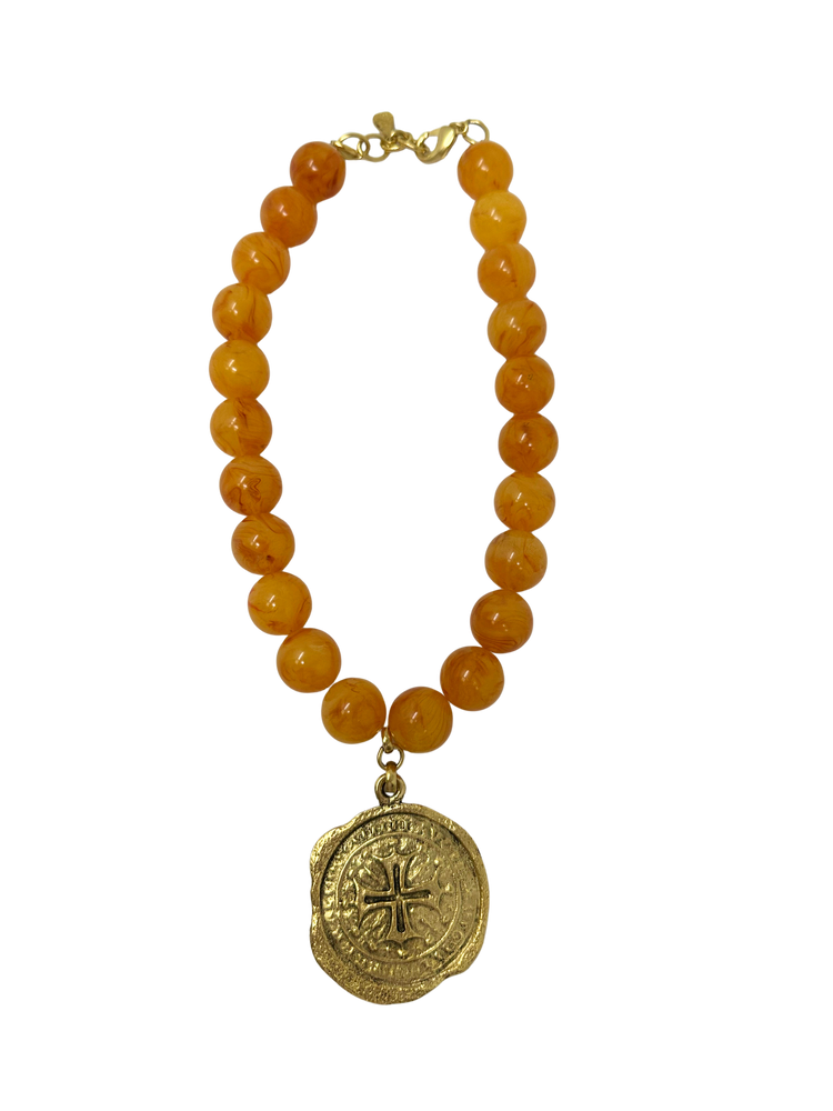 Vintage 18-inch necklace featuring amber-colored beads and a gold-tone coin medallion pendant.