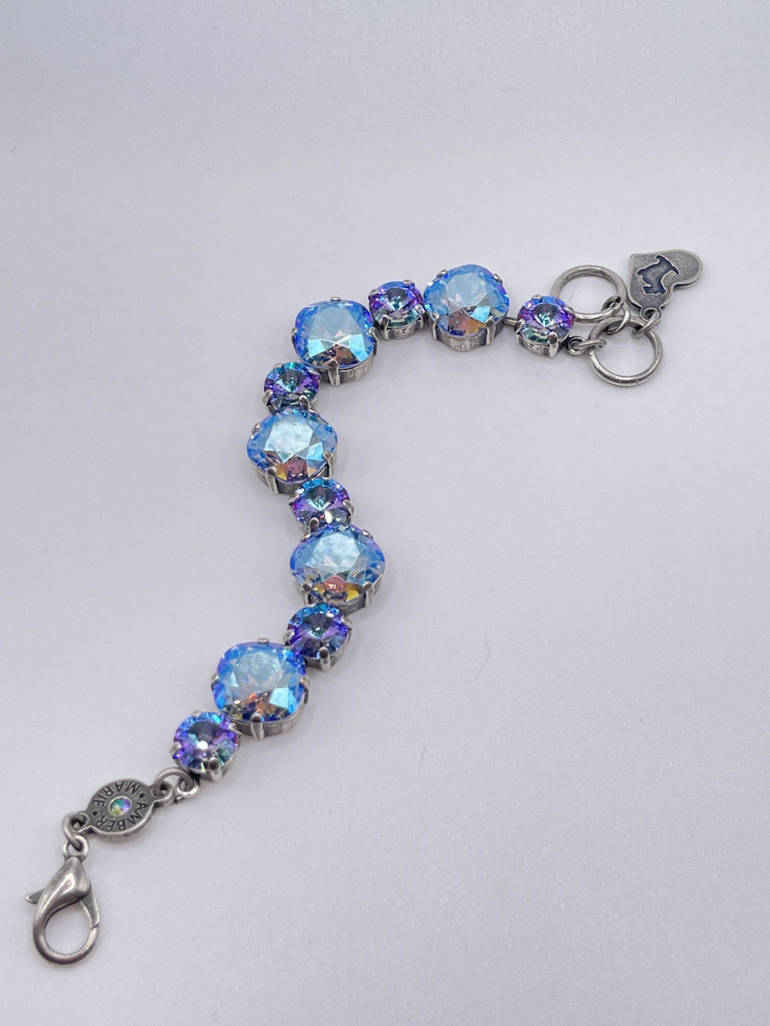 Premier Bracelet featuring iridescent blue crystals in silver settings with a heart charm.