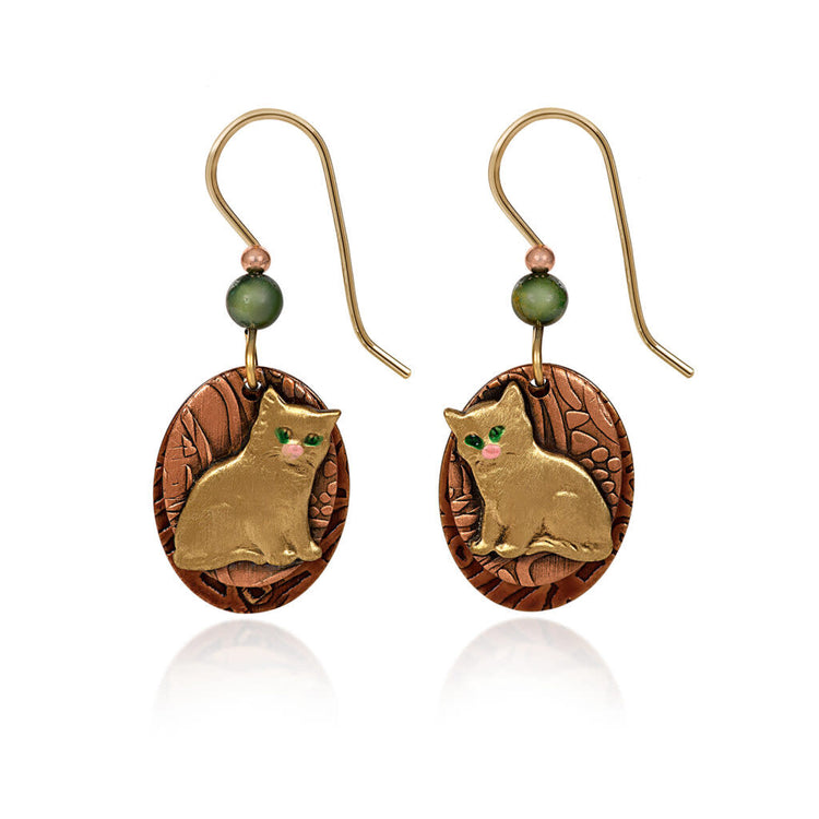 Mixed-metal oval earrings with a textured backdrop, beaded accents, and an artisan-soldered layered kitty charm in gold tone.