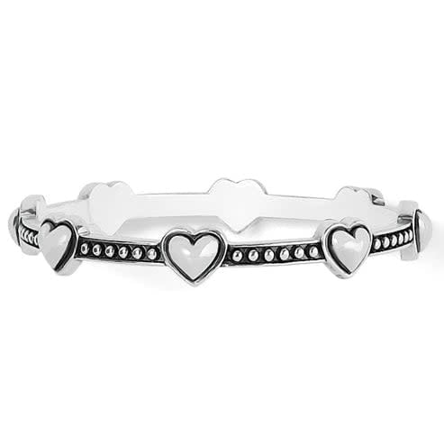 Silver plated bangle with a bold petite heart cutout on the front.