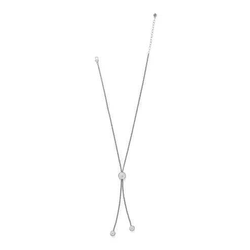 Silver-plated adjustable lariat necklace featuring a bold sphere pendant with sculpted beading and two smaller end caps.