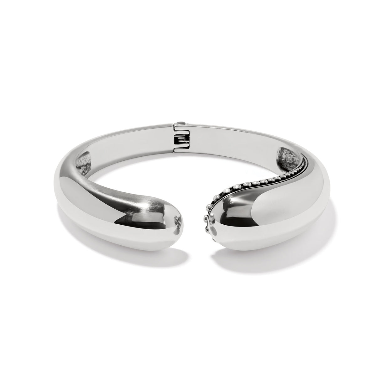 Silver plated hinged bangle with sculptural droplet curves.
