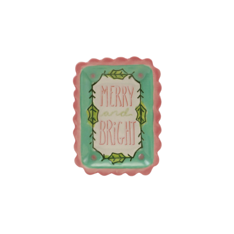 Rectangular stoneware dish with scalloped pink edges and 'Merry and Bright' holiday text.