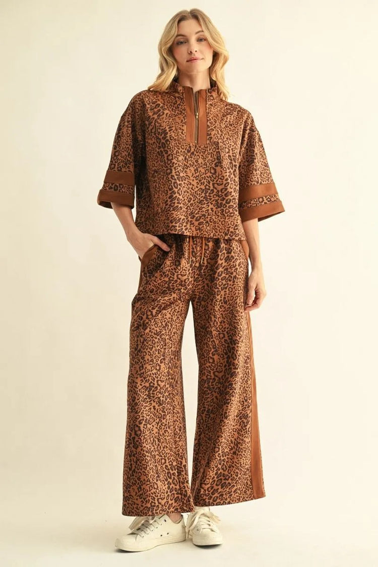 Woman wearing the Andy leopard print faux suede top with matching wide-leg pants and white sneakers.