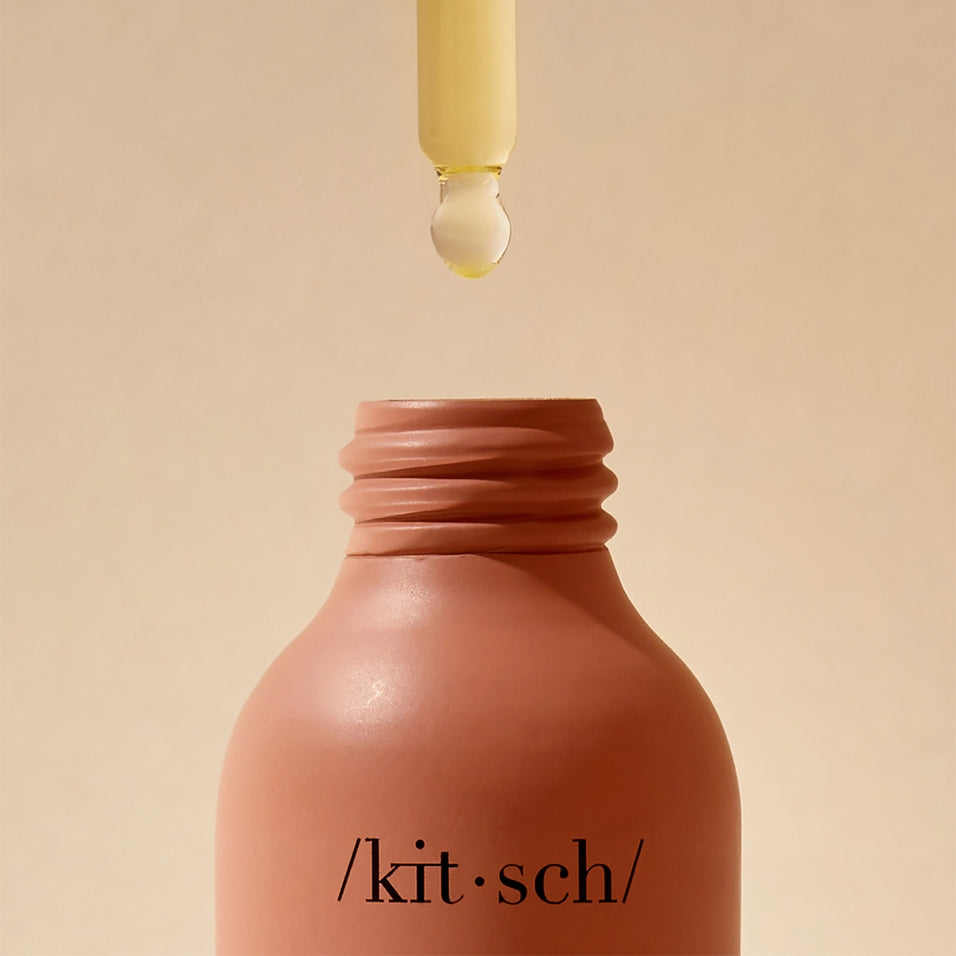 Bottle of Strengthening Hair & Scalp Oil with dropper cap