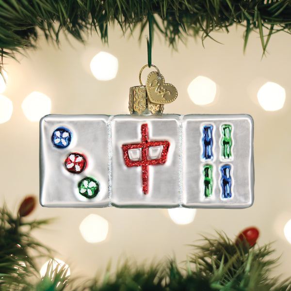 Glass Mahjong tile Christmas ornament featuring three colorful tiles hanging from a tree branch.