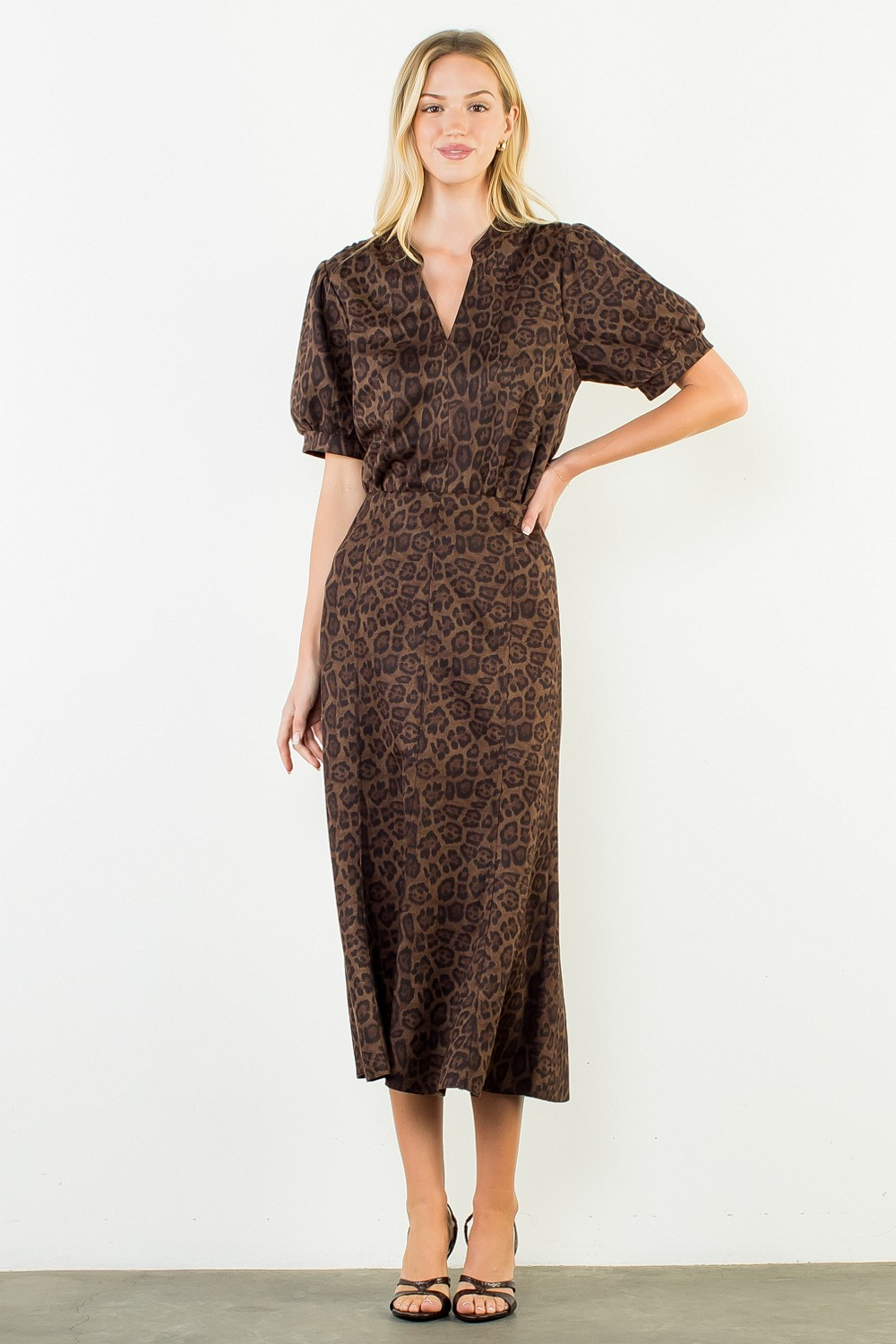 Woman wearing the Stella Suede Animal Print Top with short puff sleeves and a split neckline.