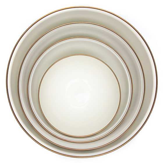 Top view of four nested Sterling Check Enamel Everyday Bowls with bronzed stainless steel rims.