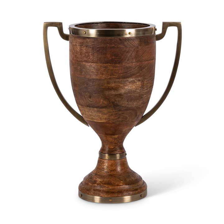 Mango wood trophy-shaped urn with two metal handles and antique gold trim on the rim and base.