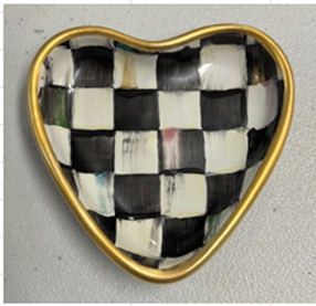 Heart-shaped trinket dish with a black and white checkered pattern and a gold-toned rim.