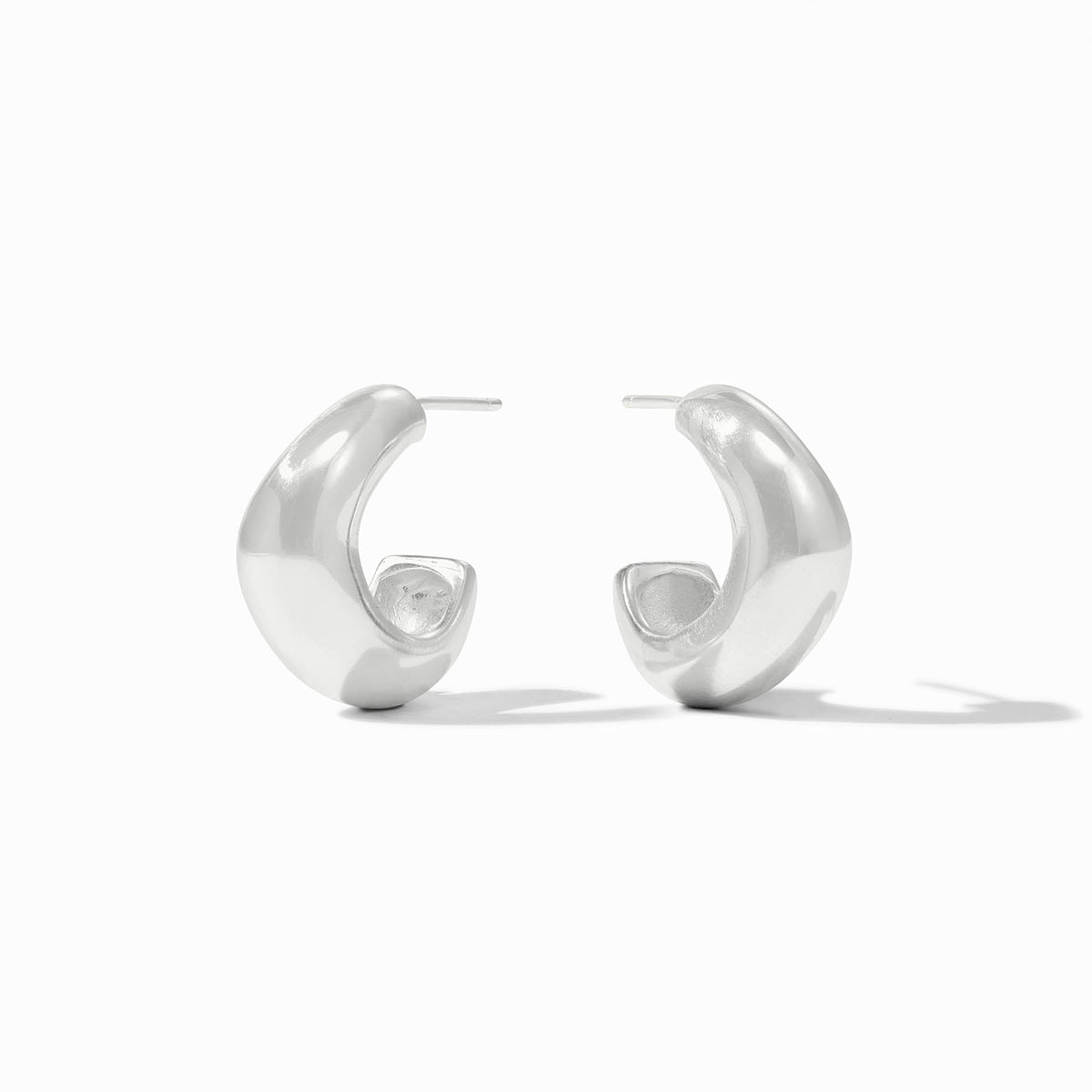 A pair of sculptural, high-polish silver wave hoop earrings for pierced ears.