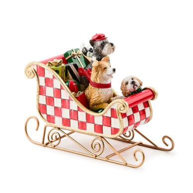 Check It Out Dog Sleigh Figurine featuring three dogs and gifts in a red and white checkered sleigh.
