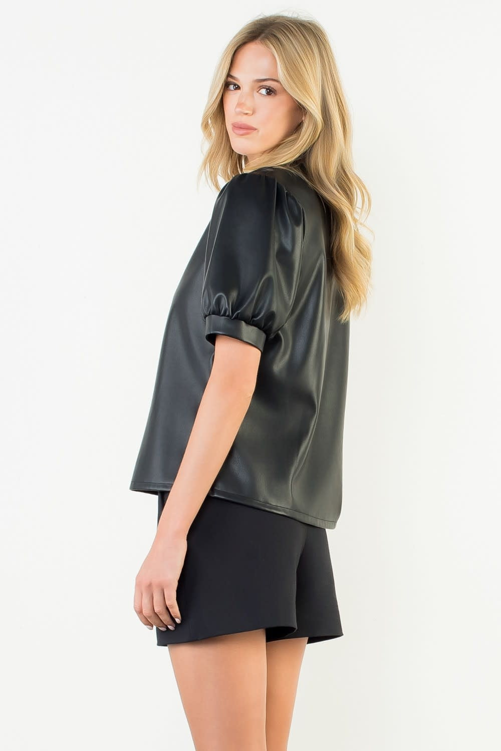 Black woven leather top with puff sleeves and structured silhouette
