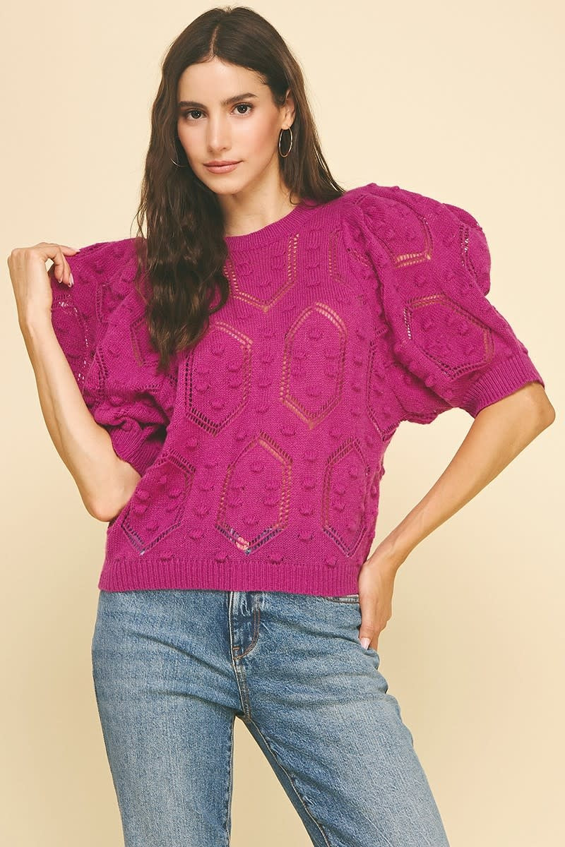 Front view of magenta puffed sleeve sweater with embroidered detail on round neck.