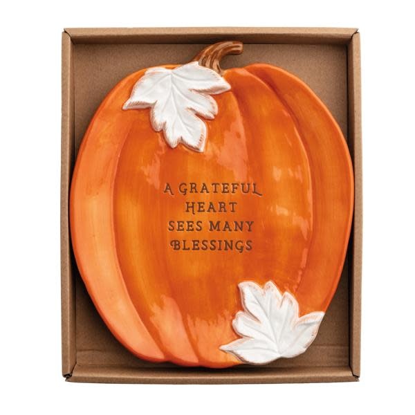 Orange stoneware pumpkin-shaped plate with a smooth rim.