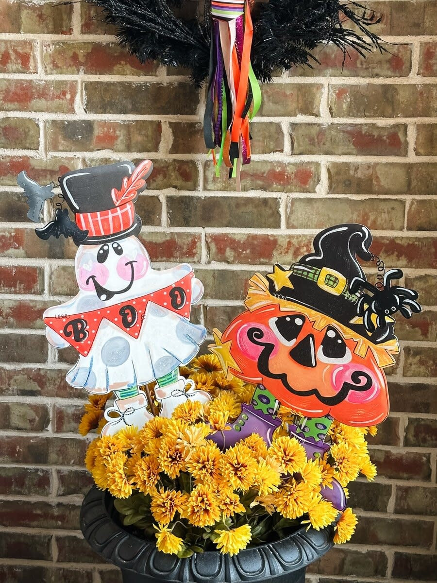 Pumpkin Witch stake decoration with black witch hat on orange pumpkin body.
