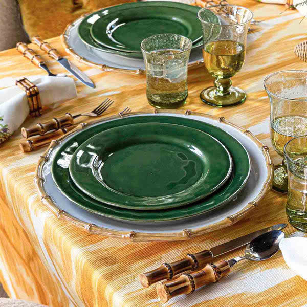Round ceramic dinner plate in basil green with a smooth glazed finish.