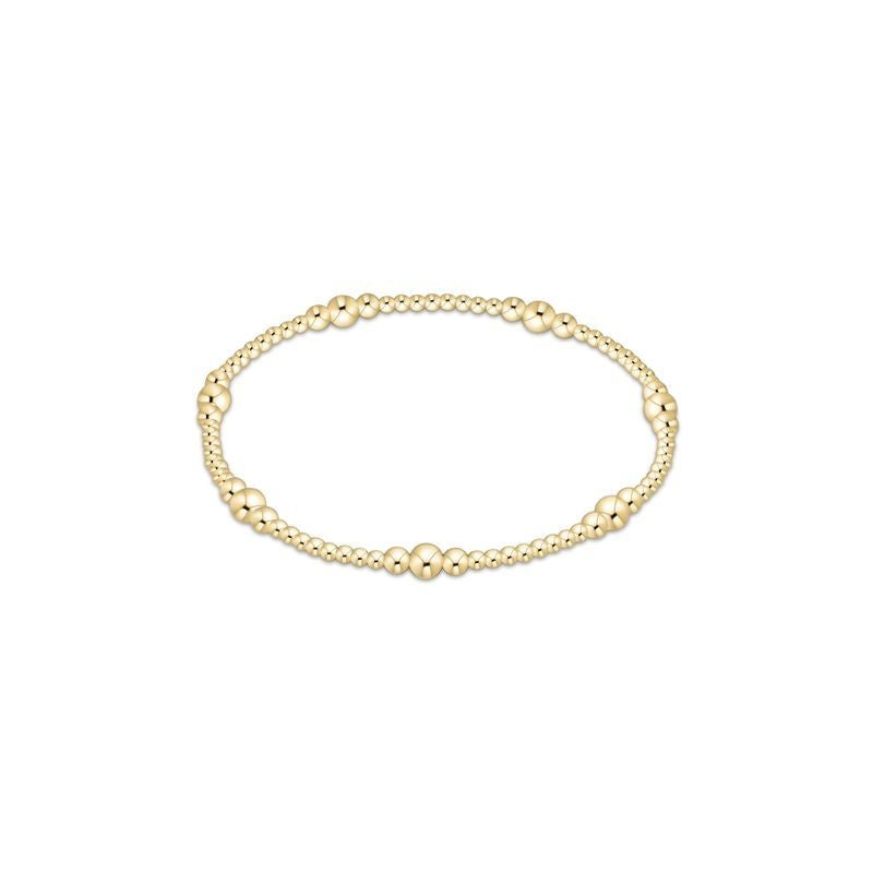 Polished gold bead bracelet with a sleek, stacked silhouette.