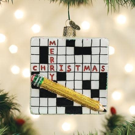 Red wooden crossword puzzle ornament with white grid and black lettering.
