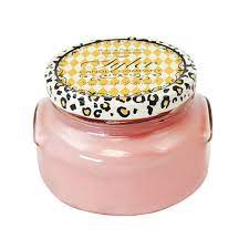 A white ceramic jar containing a Tyler Candle with visible wax pool.