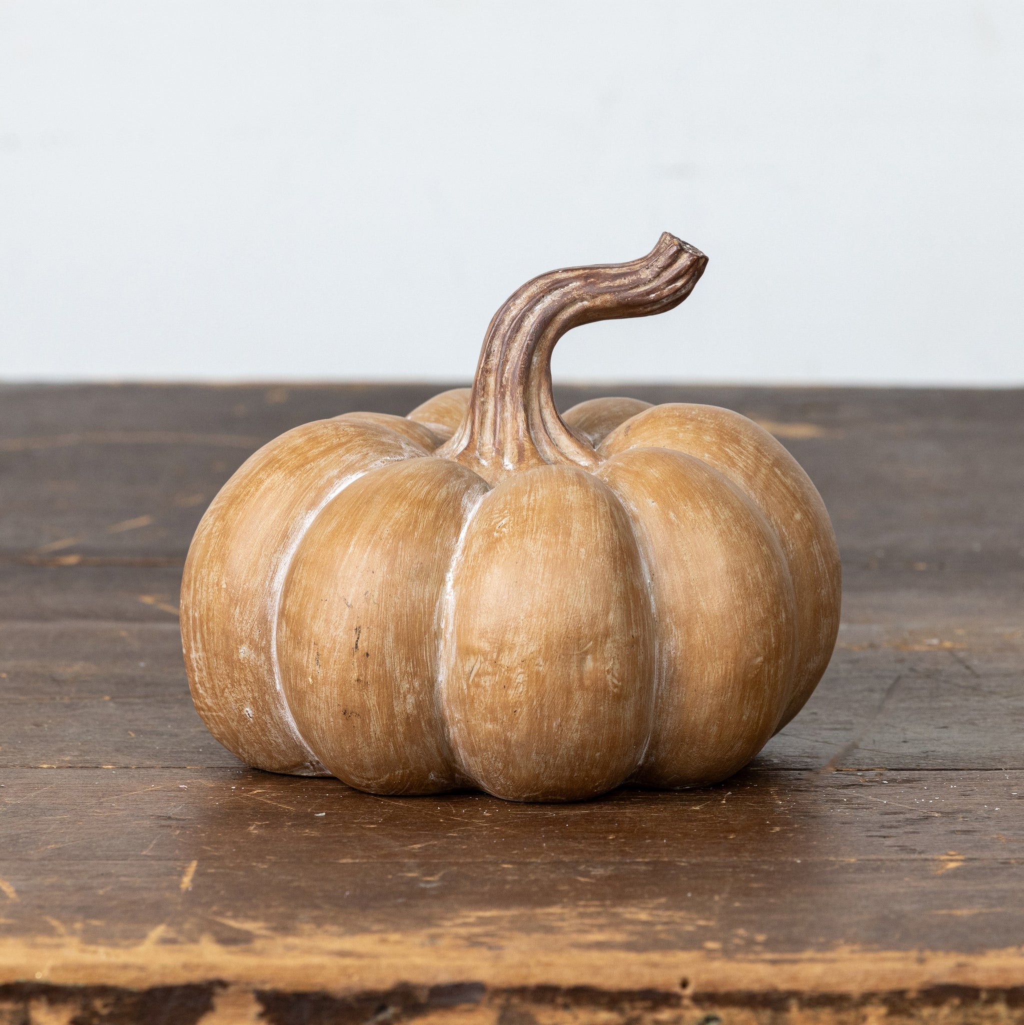 Brown resin pumpkin with textured surface in a classic fall shape.
