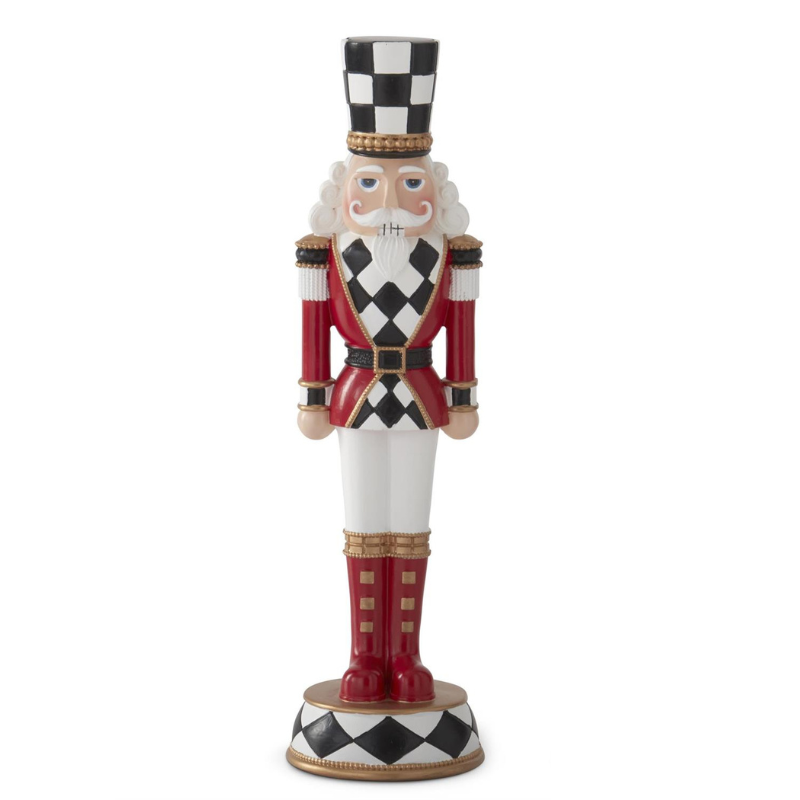 Red and black harlequin check nutcracker figurine with white pants and a tall checkered hat.