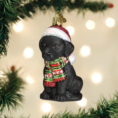 Black Labrador puppy ornament with a glossy finish in black color.