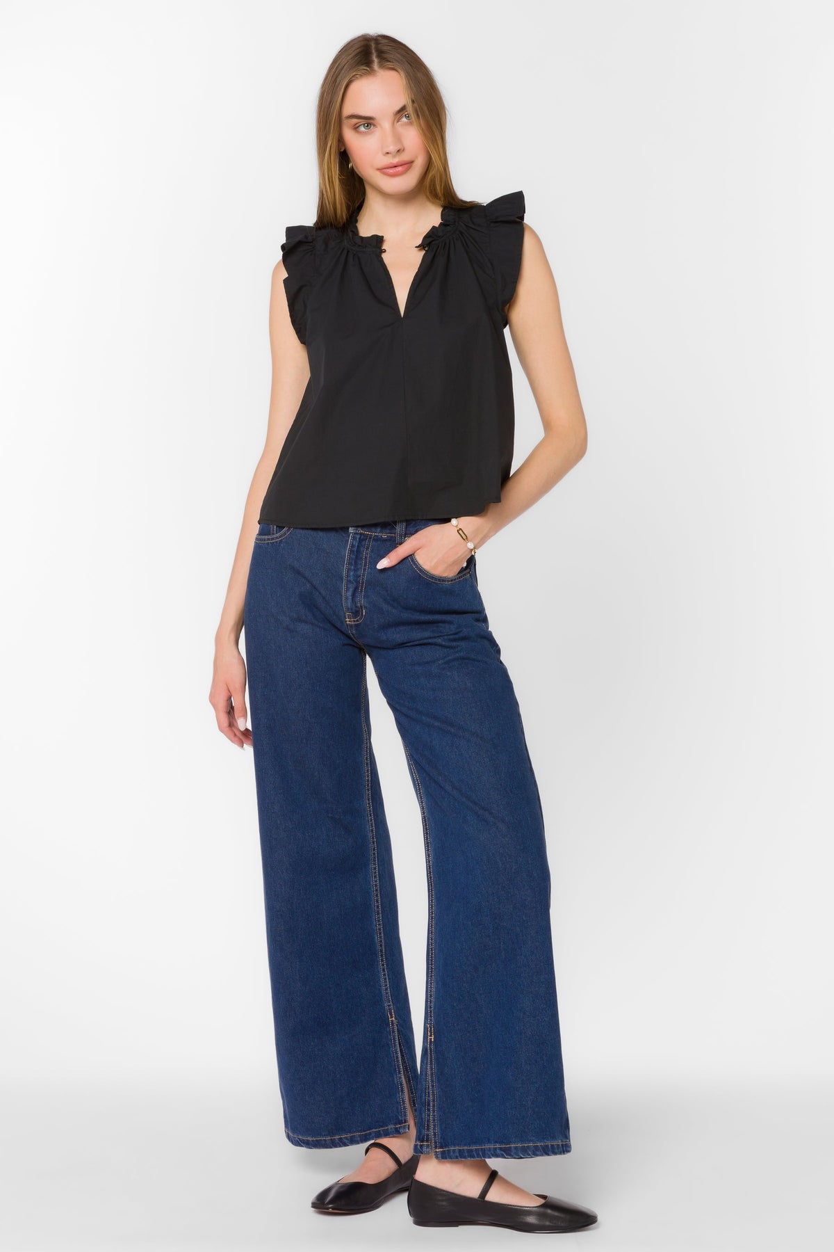 Black cotton poplin sleeveless top with Mandarin collar, V-neckline, ruffle edge, and tie detail.