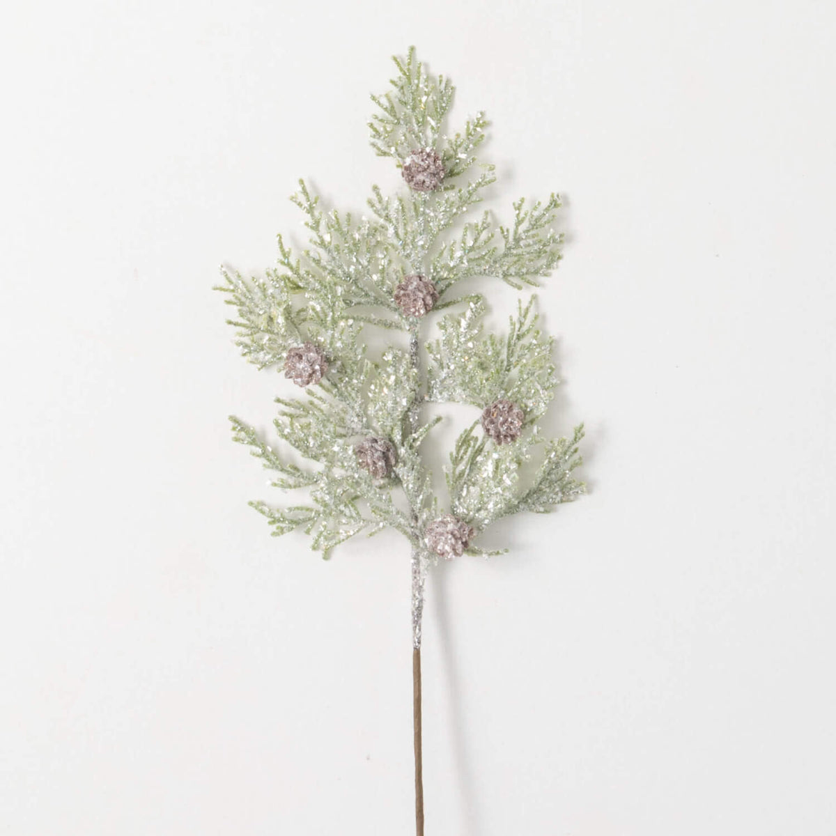 Green plastic frosted pick with pinecone accents on a white background