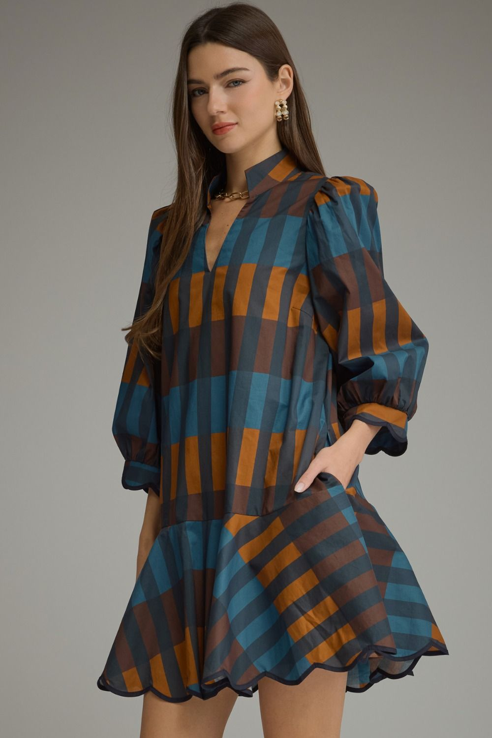 Woman wearing the Harper Plaid ¾ Balloon Sleeve Mini Dress in a blue and brown checkered pattern.