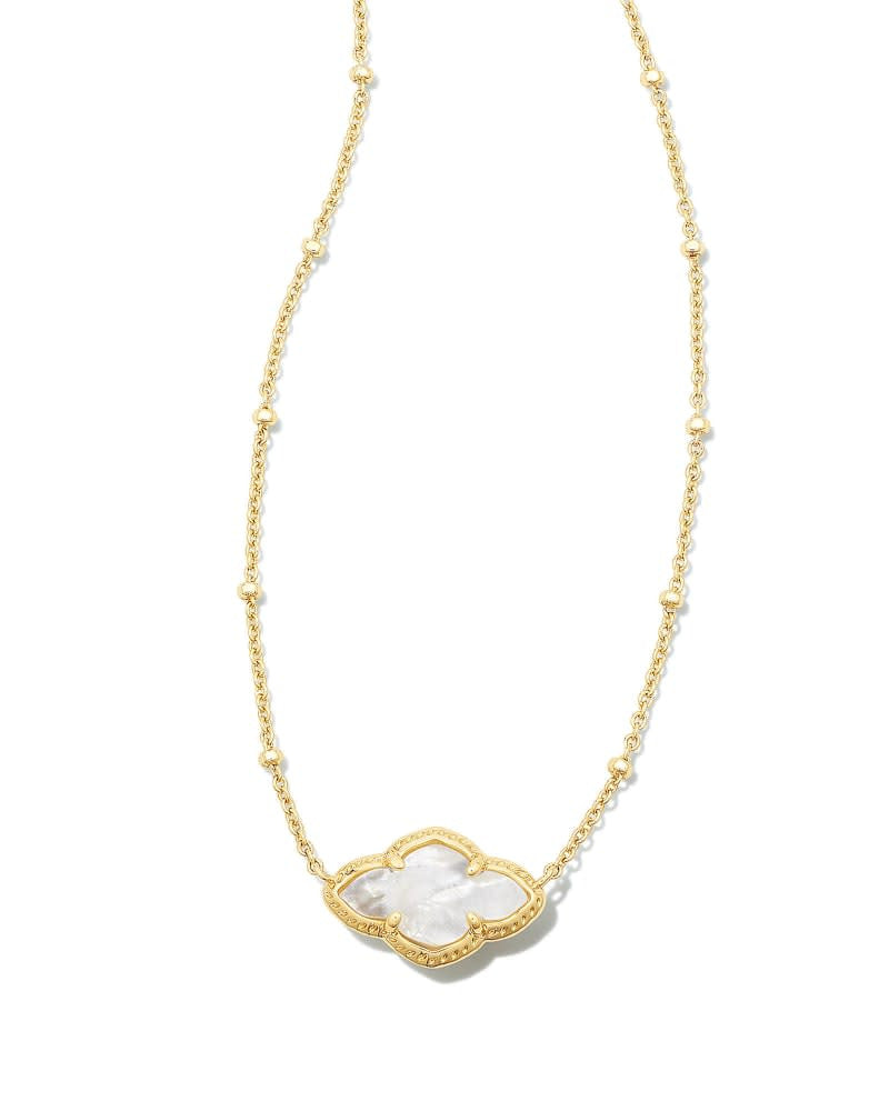 Abbie Pendant Necklace in gold with an elongated white medallion pendant on a beaded chain.