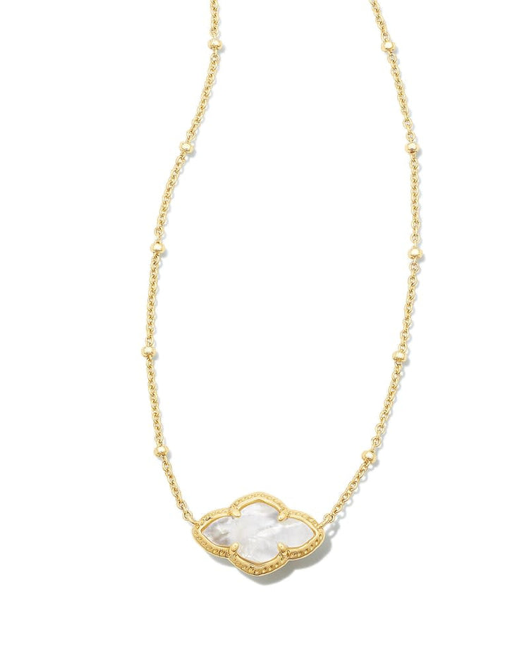 Abbie Pendant Necklace in gold with an elongated white medallion pendant on a beaded chain.