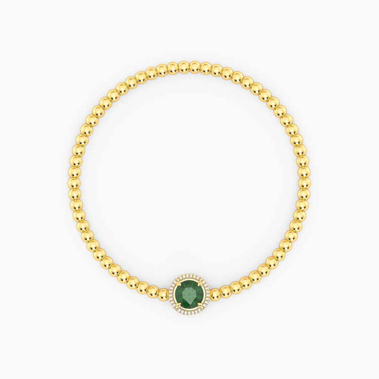 Gold-plated beaded bracelet with a round green center stone and a diamond halo.