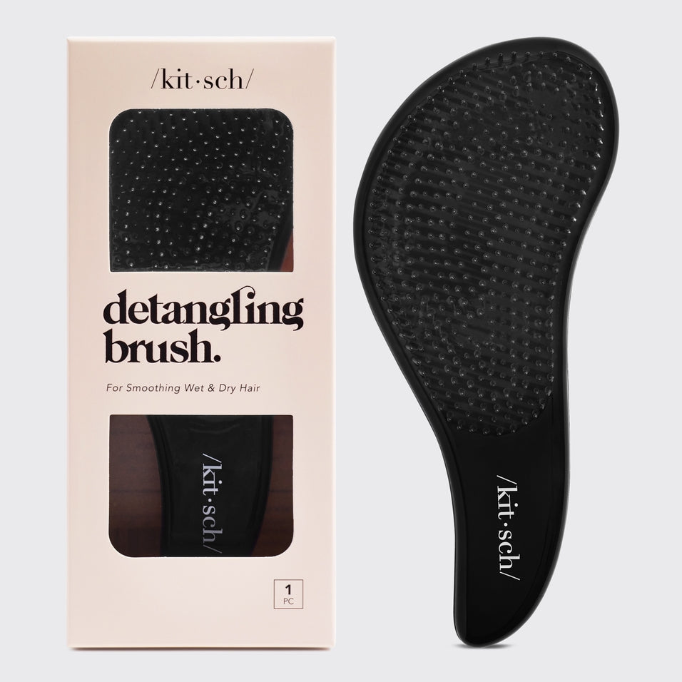 Detangling brush with flexible bristles in sleek black finish.
