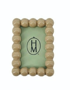 Tan rectangle resin frame magnet with a beaded border design.