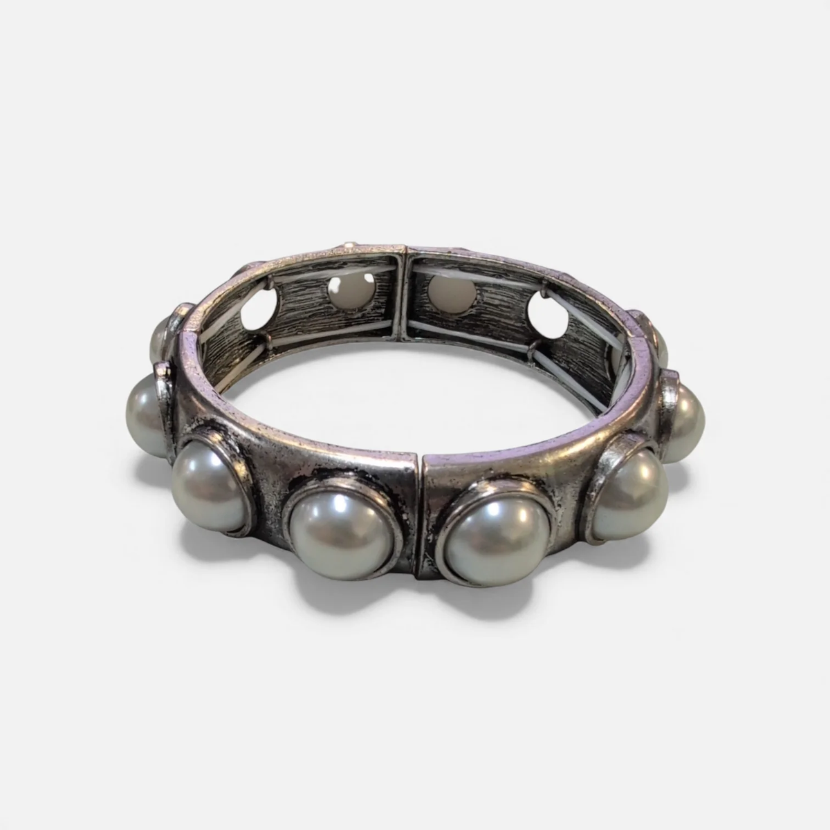 Silver-toned stretch cuff bracelet featuring large inset faux pearls.